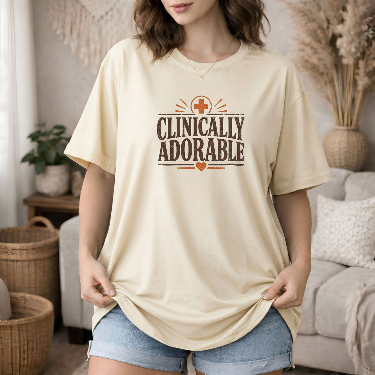 Ivory garment-dyed cotton tee printed with "Clinically Adorable".