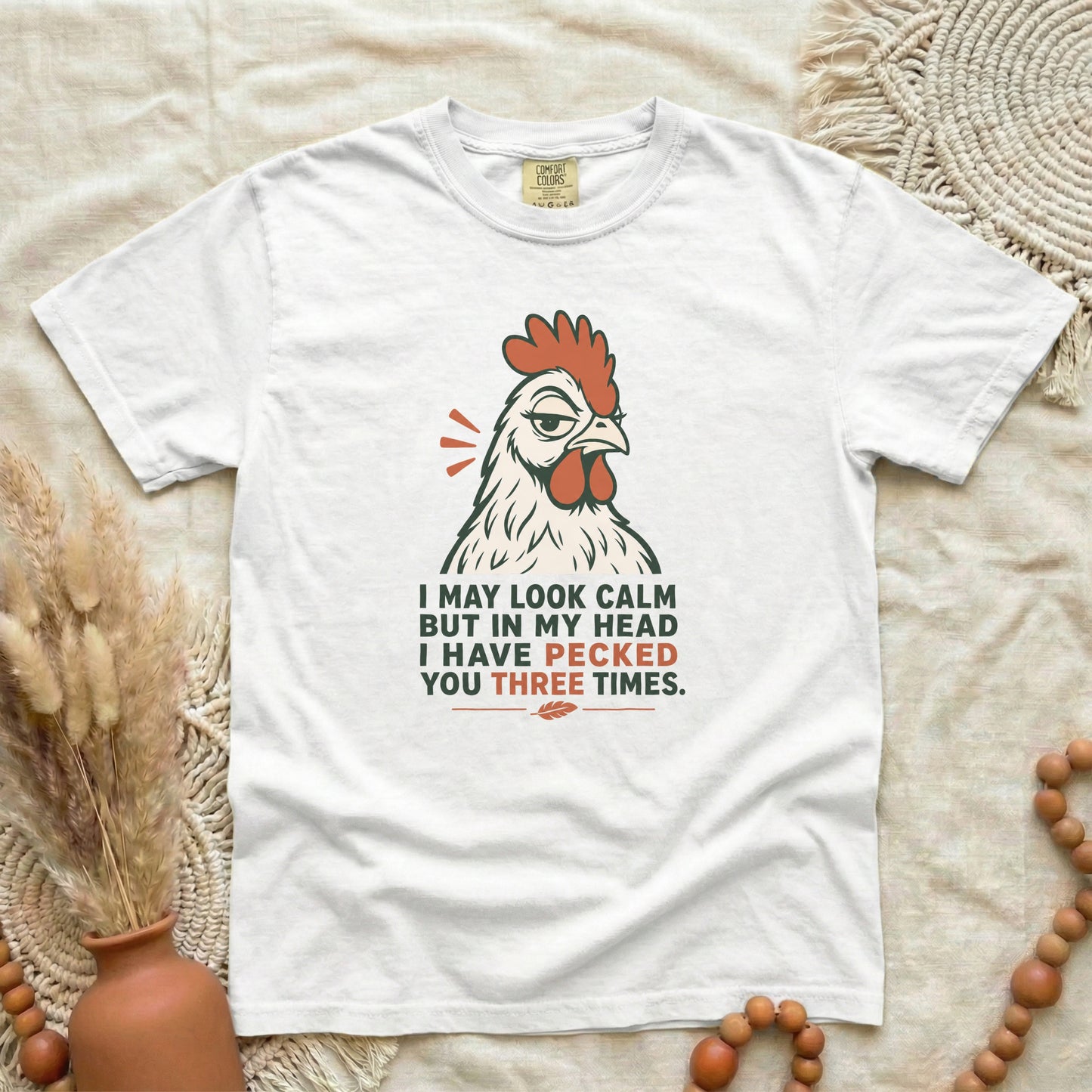 White garment-dyed cotton tee printed with "I May Look Calm But In My Head I Have Pecked You Three Times".