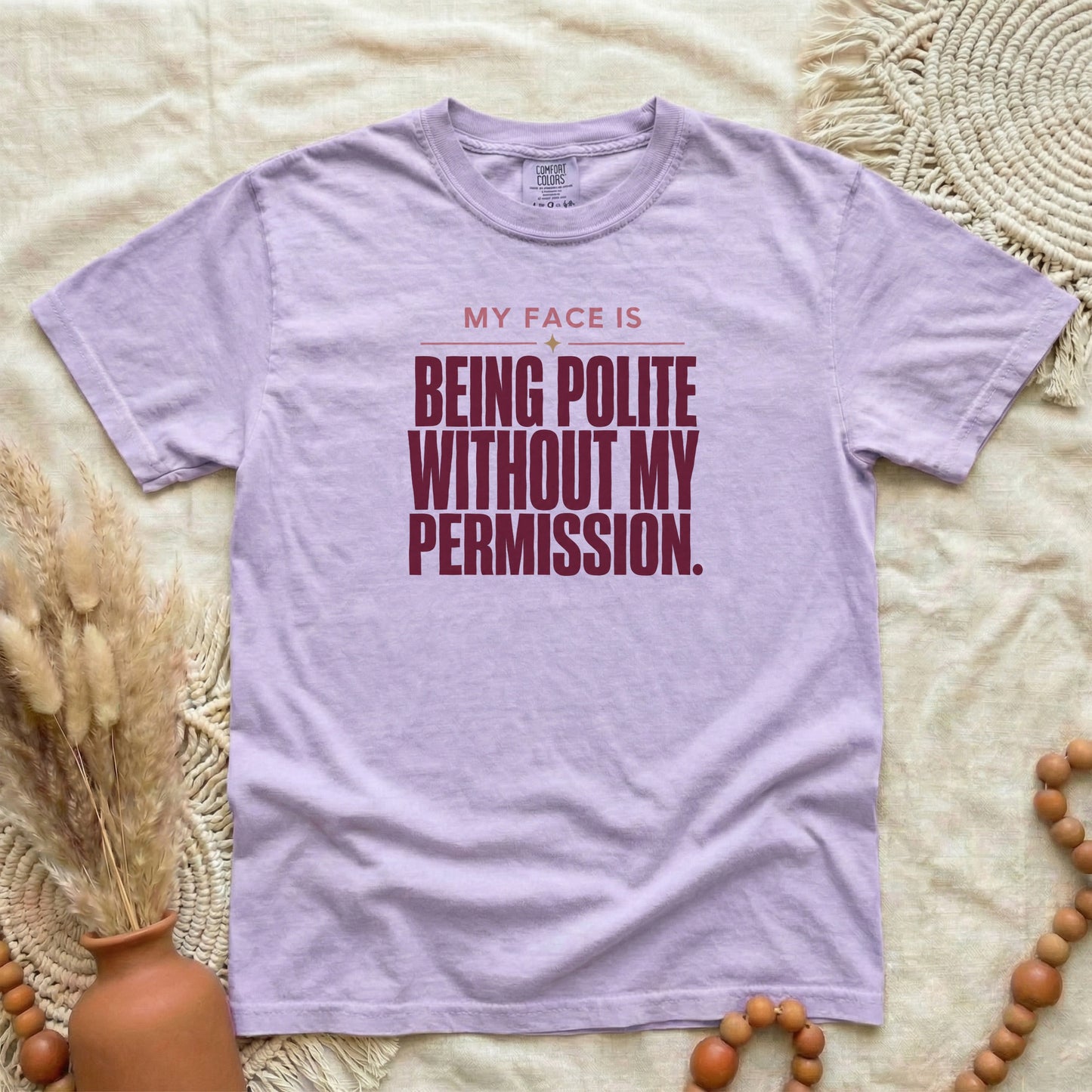 Orchid garment-dyed cotton tee printed with "My Face Is Being Polite Without My Permission".