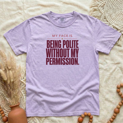 Orchid garment-dyed cotton tee printed with "My Face Is Being Polite Without My Permission".