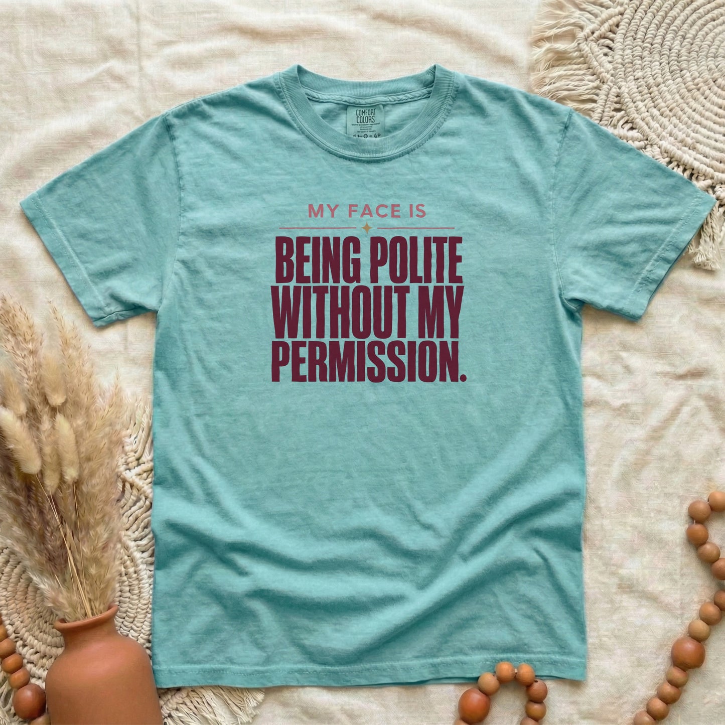 Chalky Mint garment-dyed cotton tee printed with "My Face Is Being Polite Without My Permission".