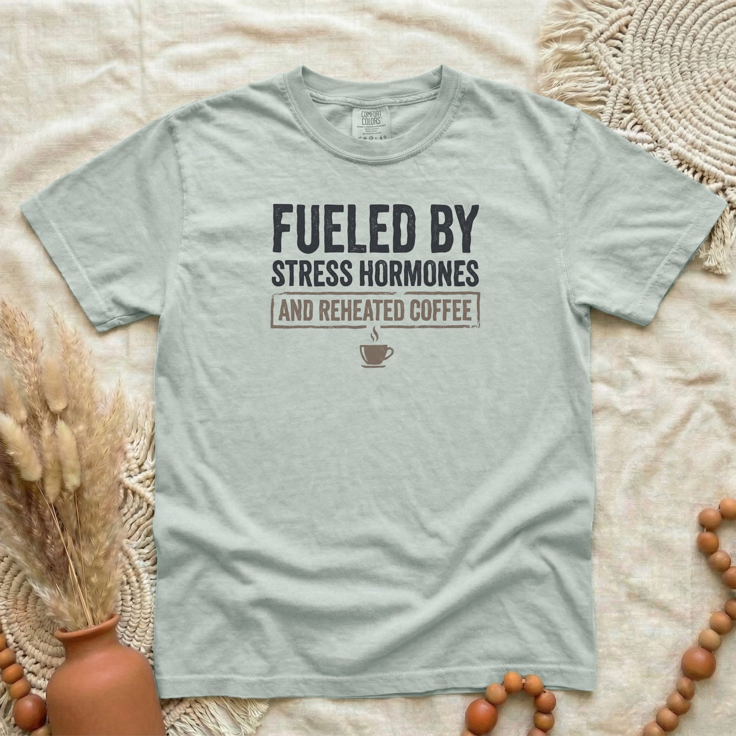 Bay garment-dyed cotton tee printed with "Fueled By Stress Hormones And Reheated Coffee".