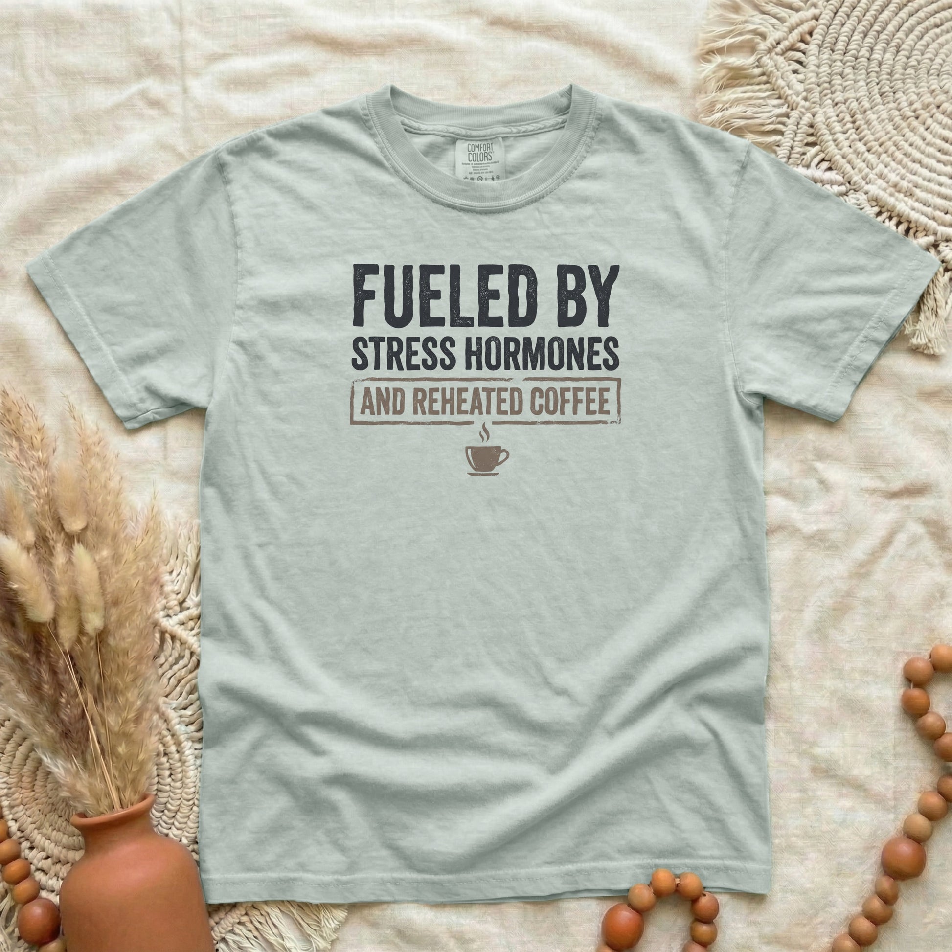 Bay garment-dyed cotton tee printed with "Fueled By Stress Hormones And Reheated Coffee".