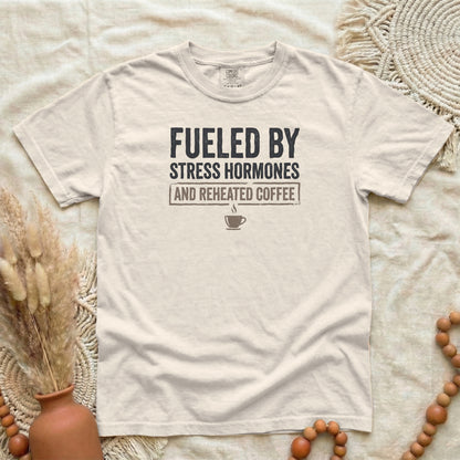 Ivory garment-dyed cotton tee printed with "Fueled By Stress Hormones And Reheated Coffee".