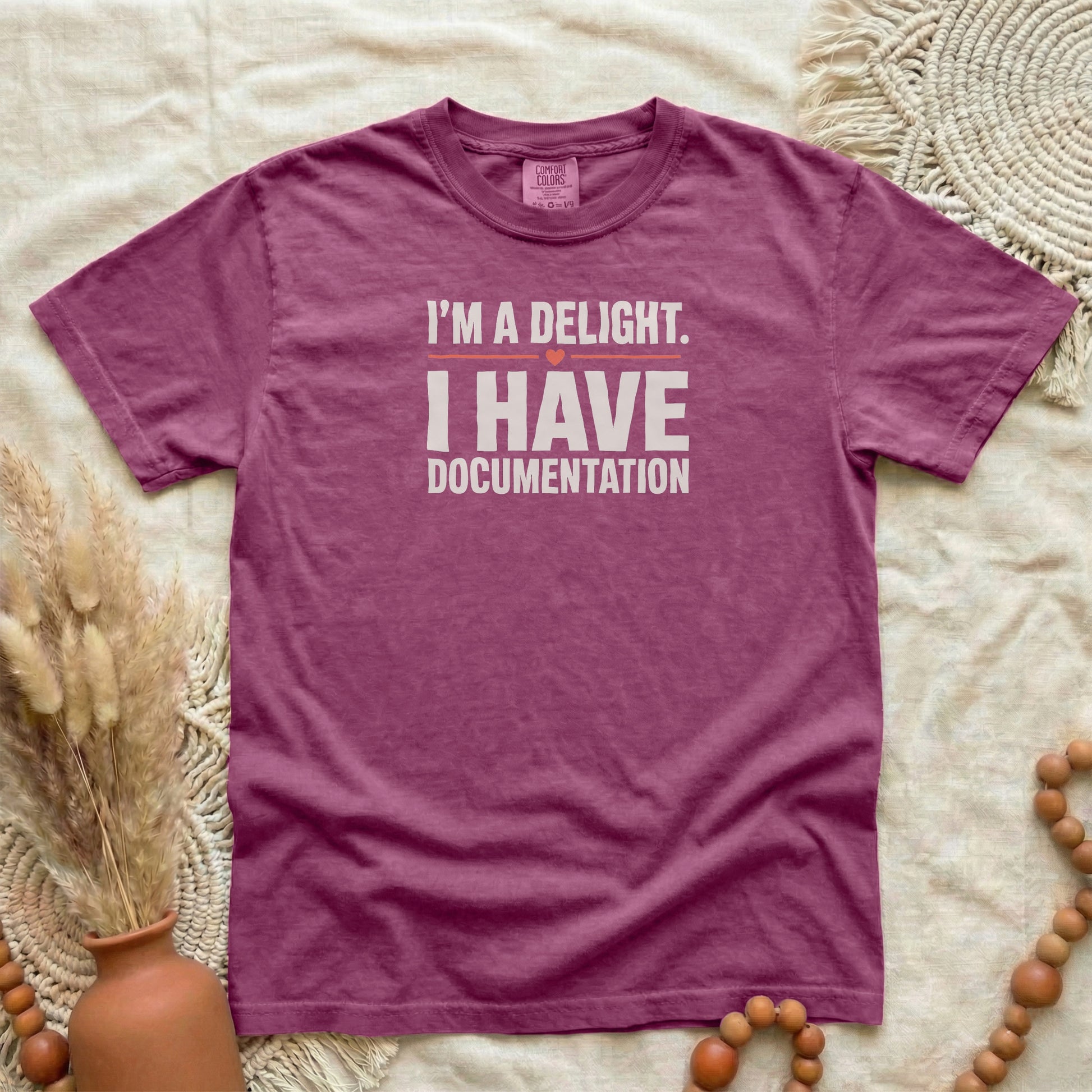 Berry garment-dyed cotton tee printed with "I'm A Delight. I Have Documentation."