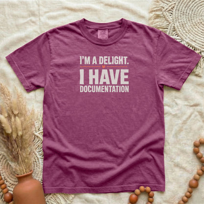 Berry garment-dyed cotton tee printed with "I'm A Delight. I Have Documentation."