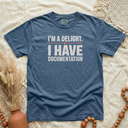 Denim garment-dyed cotton tee printed with "I'm A Delight. I Have Documentation."