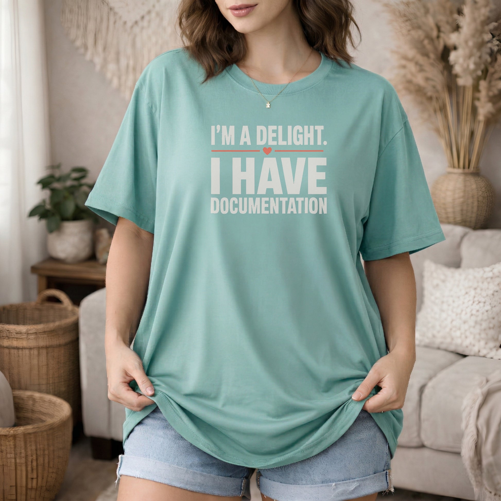 Seafoam garment-dyed cotton tee printed with "I'm A Delight. I Have Documentation."