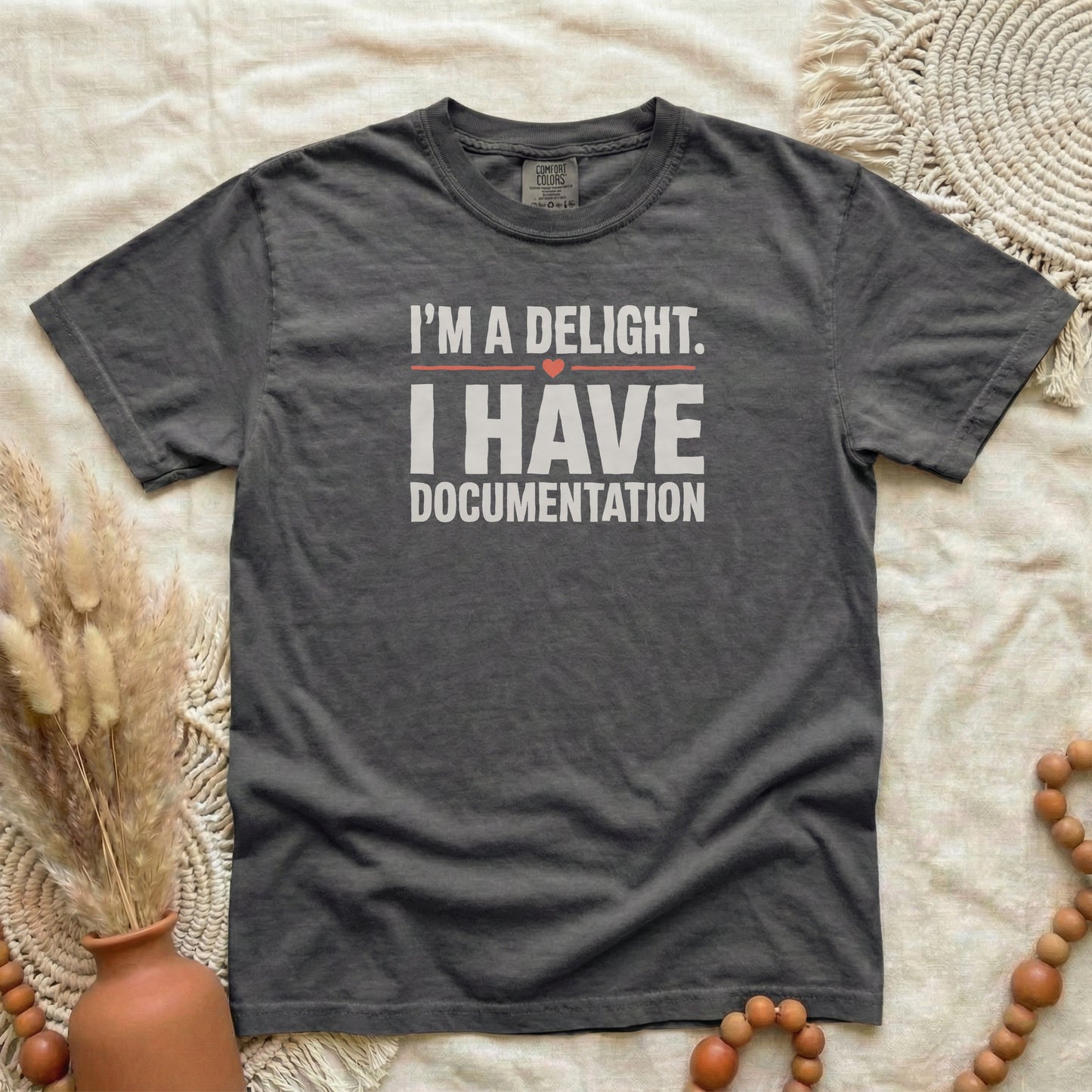 Pepper garment-dyed cotton tee printed with "I'm A Delight. I Have Documentation."