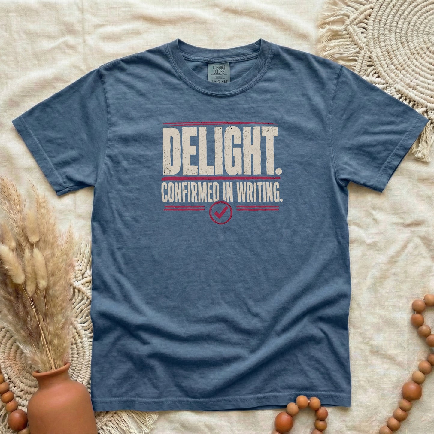 Denim garment-dyed cotton tee printed with "Delight. Confirmed In Writing."