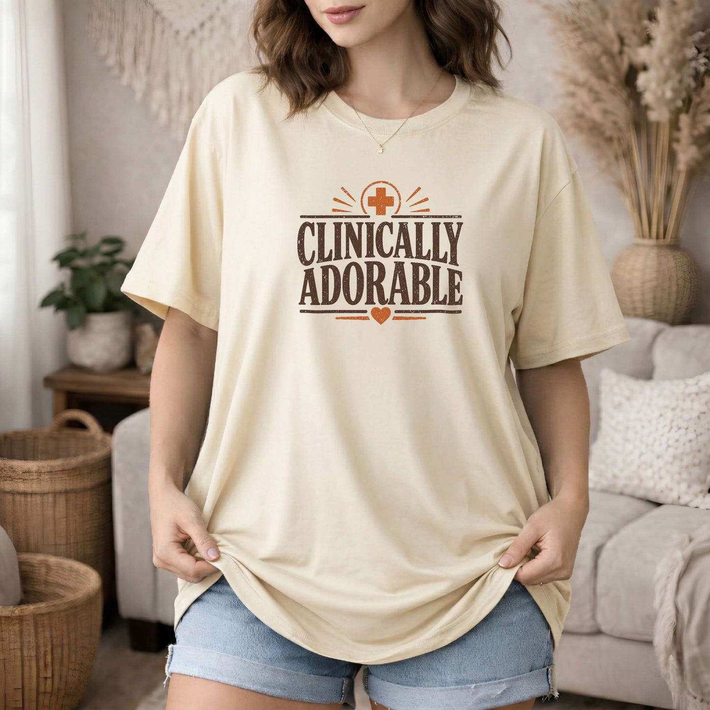 Ivory garment-dyed cotton tee printed with "Clinically Adorable".