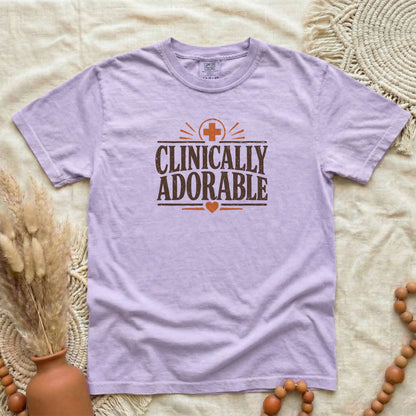 Orchid garment-dyed cotton tee printed with "Clinically Adorable".