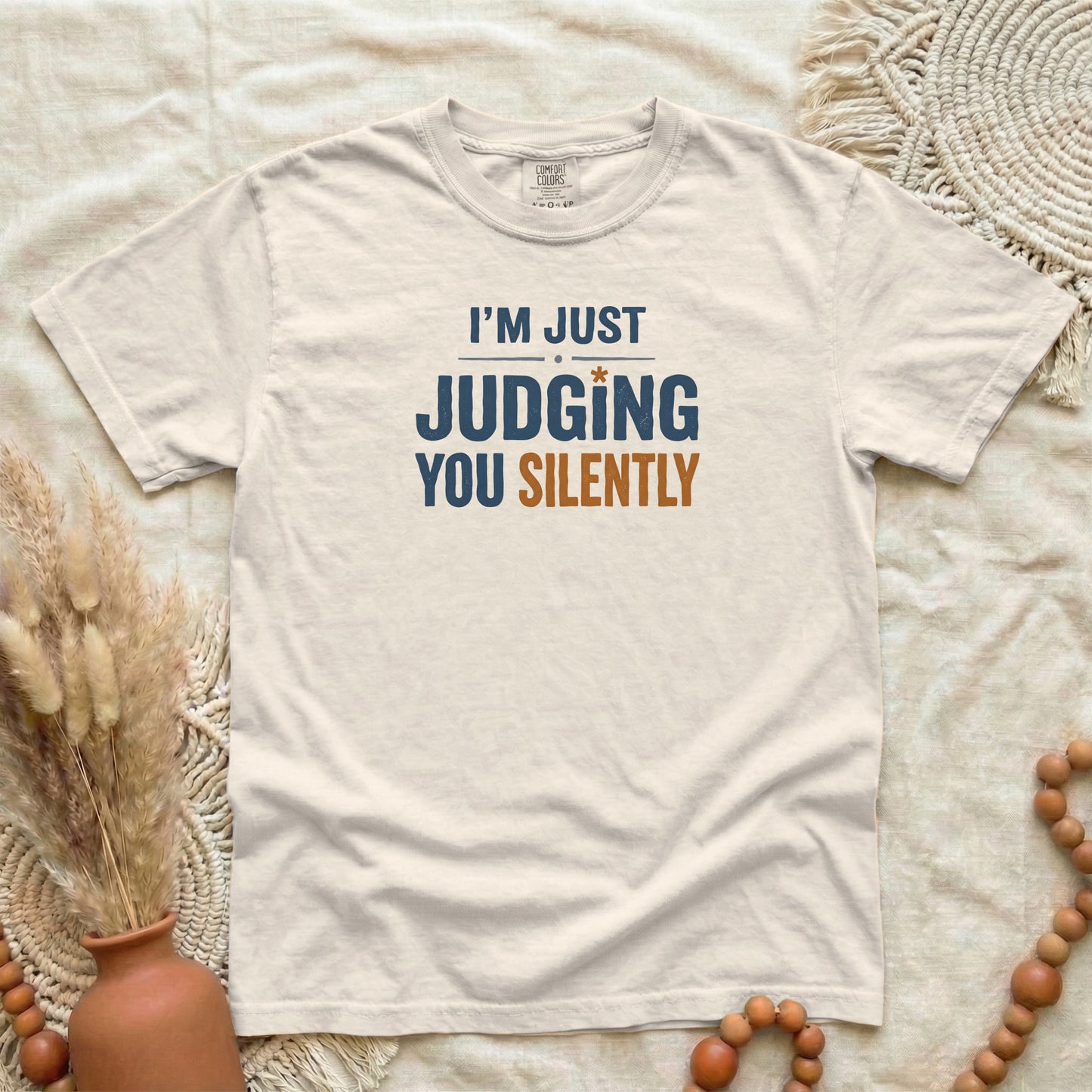 Ivory garment-dyed cotton tee printed with "Judging You Silently".