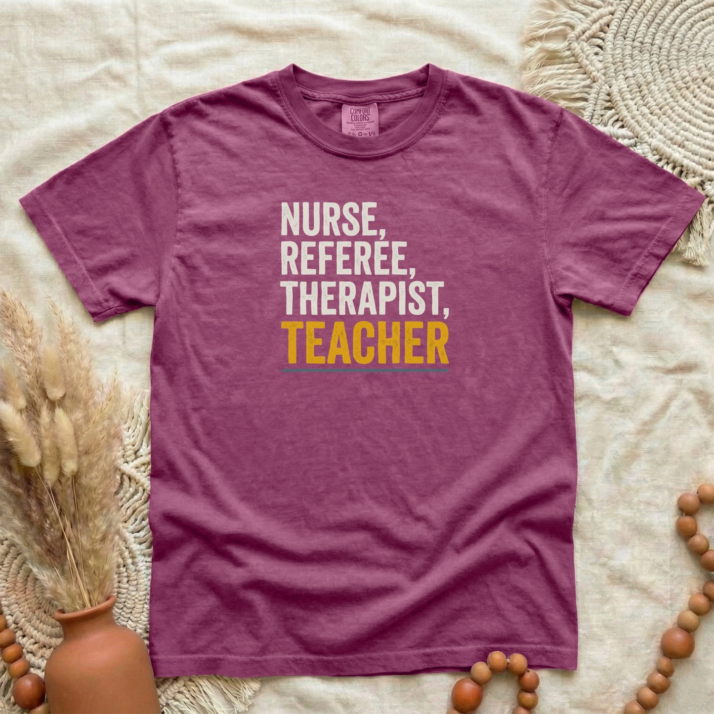 Berry garment-dyed cotton tee printed with "Nurse, Referee, Therapist, Teacher".