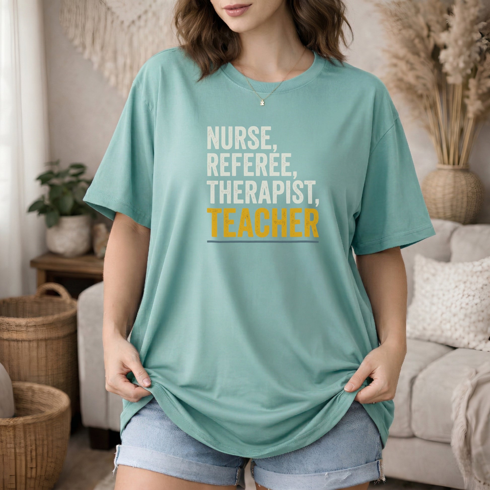 Island Green garment-dyed cotton tee printed with "Nurse, Referee, Therapist, Teacher".