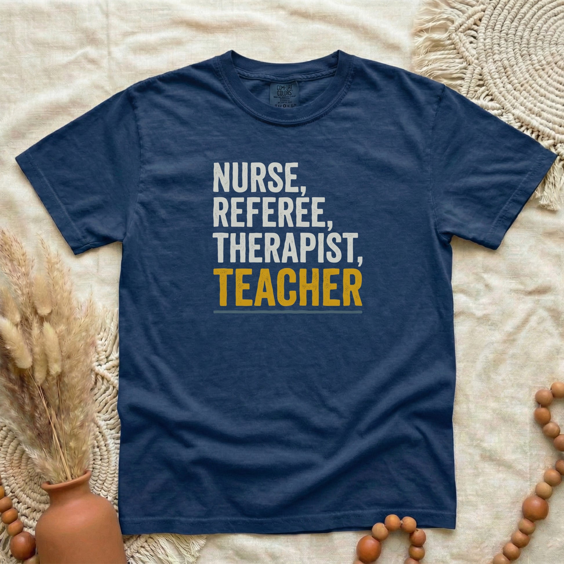 True Navy garment-dyed cotton tee printed with "Nurse, Referee, Therapist, Teacher".
