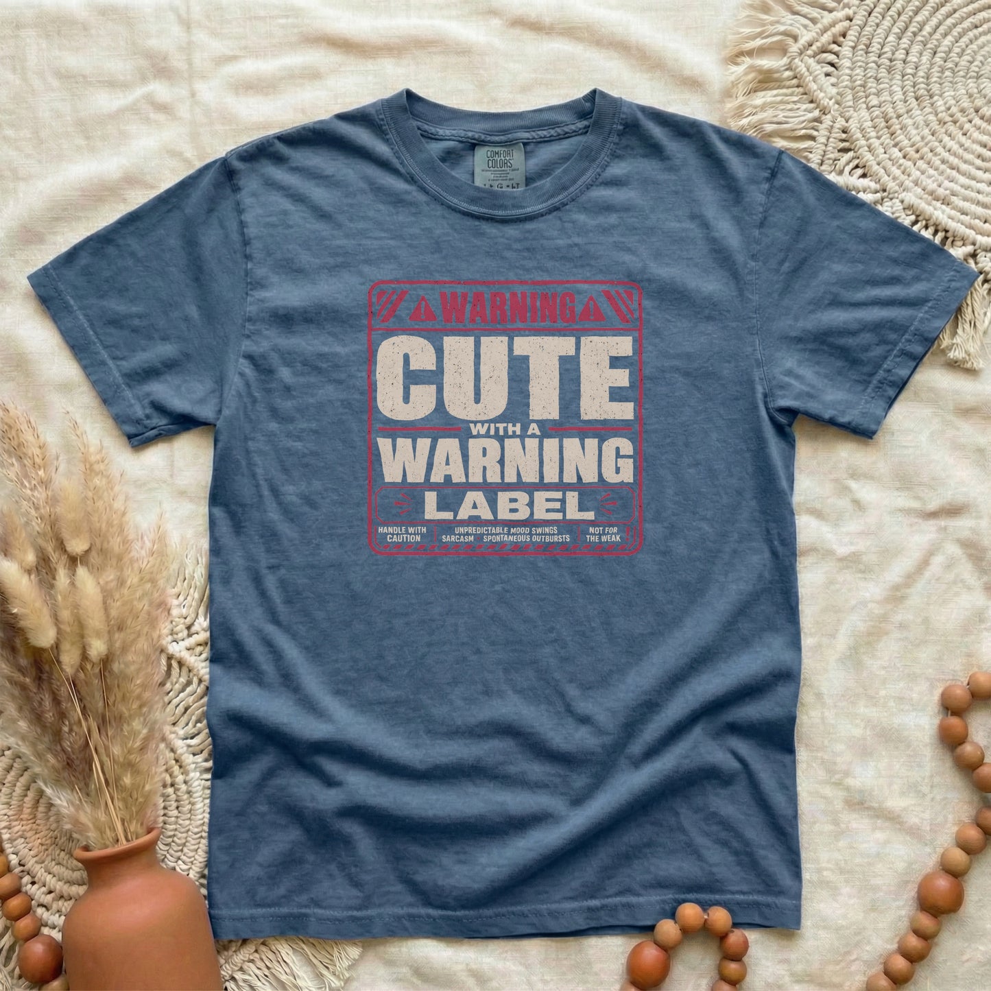 Denim garment-dyed cotton tee printed with "Cute With A Warning Label".