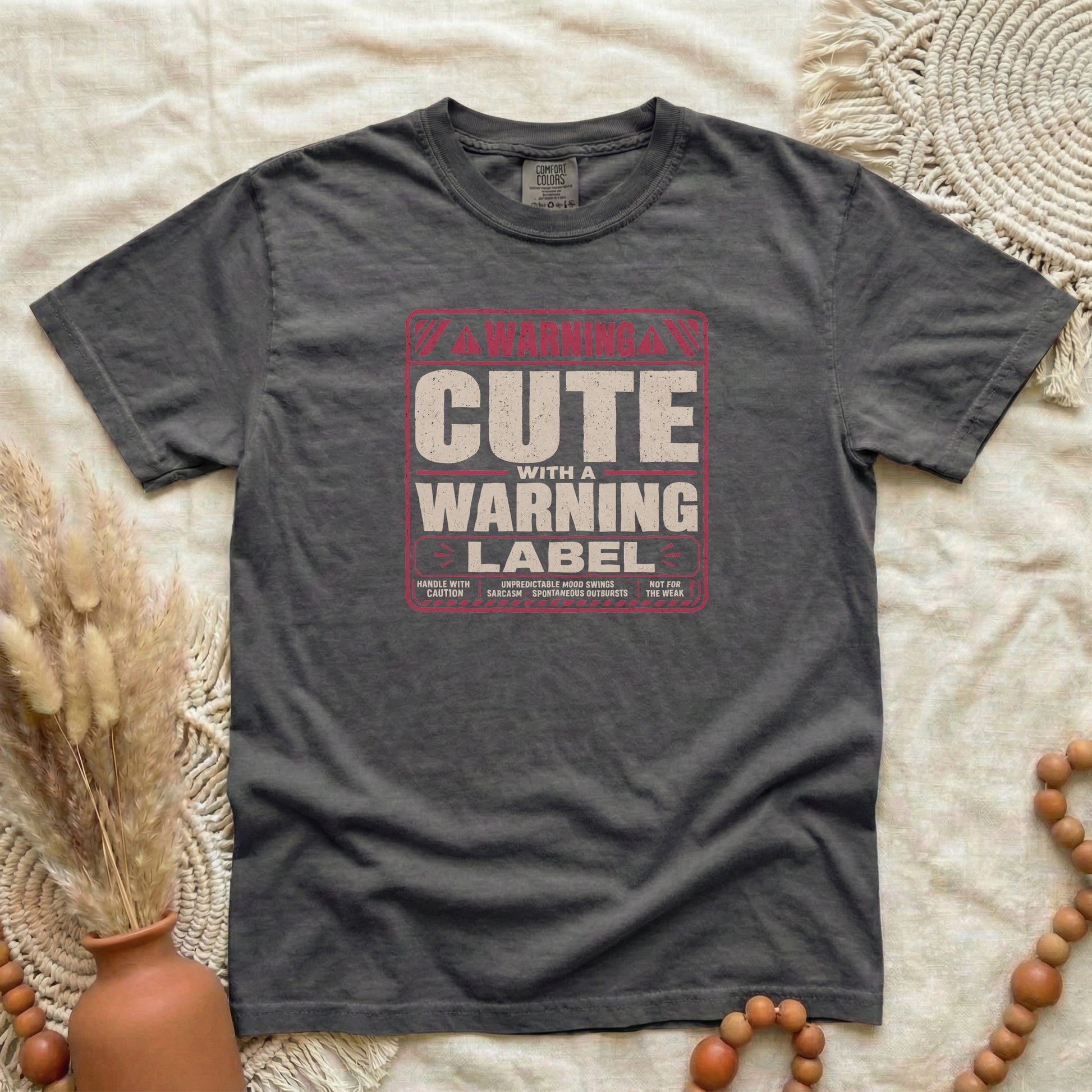 Pepper garment-dyed cotton tee printed with "Cute With A Warning Label".
