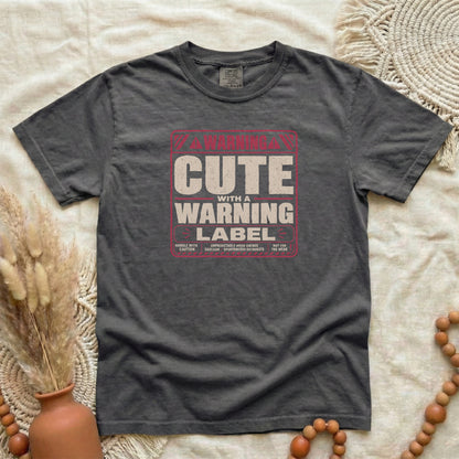 Pepper garment-dyed cotton tee printed with "Cute With A Warning Label".