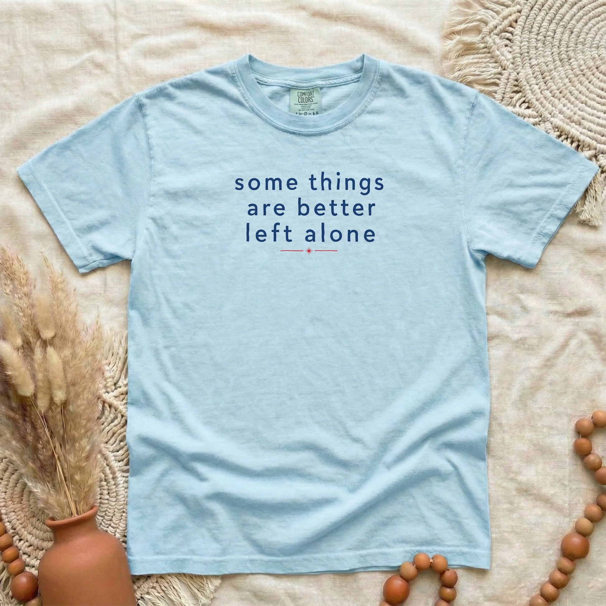 Chambray garment-dyed cotton tee printed with "Some Things Are Better Left Alone".