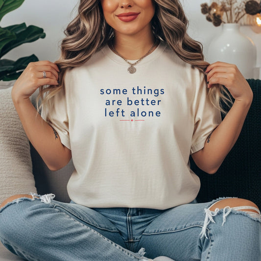 Ivory garment-dyed cotton tee printed with "Some Things Are Better Left Alone".
