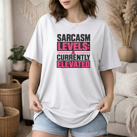 White garment-dyed cotton tee printed with "Sarcasm Levels: Currently Elevated".