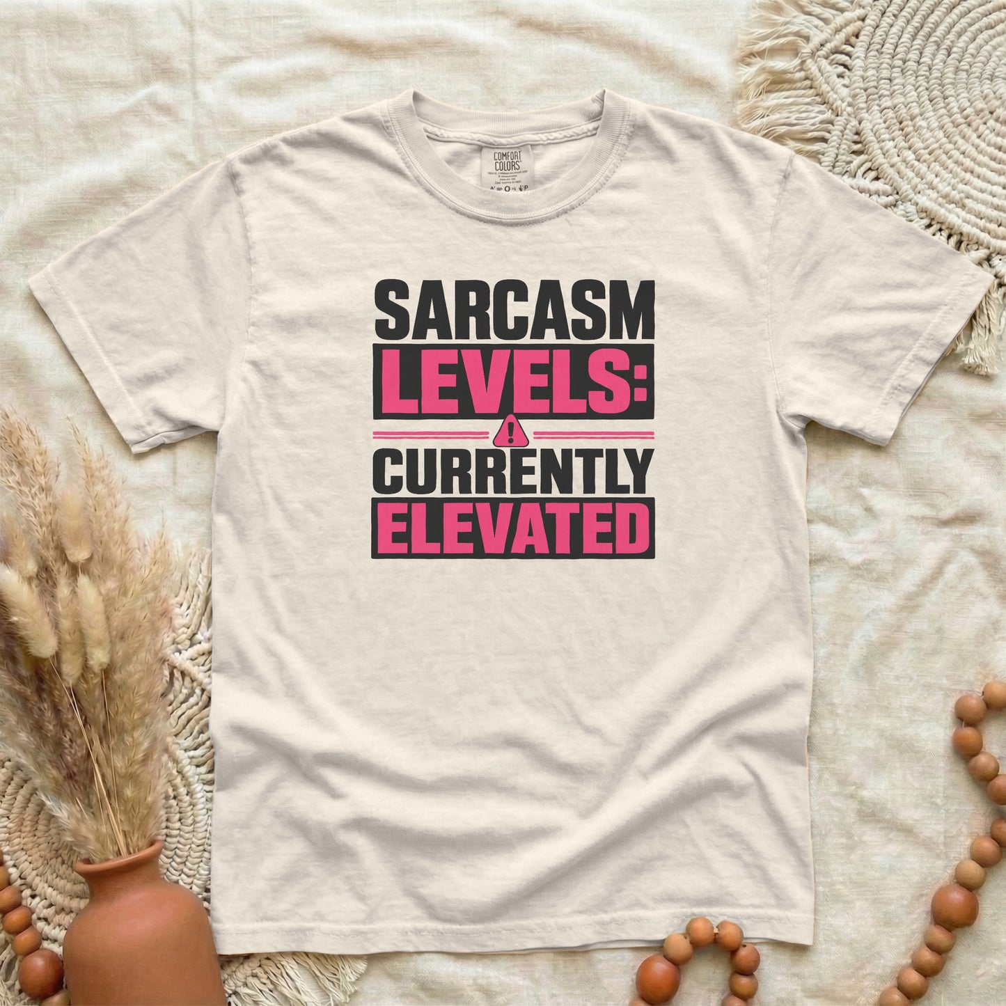 Ivory garment-dyed cotton tee printed with "Sarcasm Levels: Currently Elevated".
