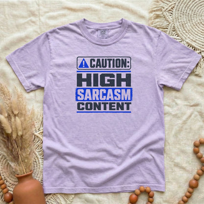Orchid garment-dyed cotton tee printed with "Caution: High Sarcasm Content".