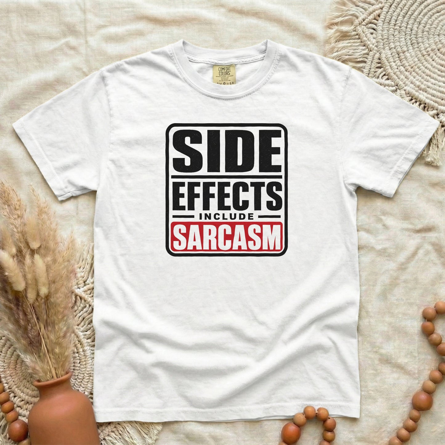 White garment-dyed cotton tee printed with "Side Effects Include Sarcasm".