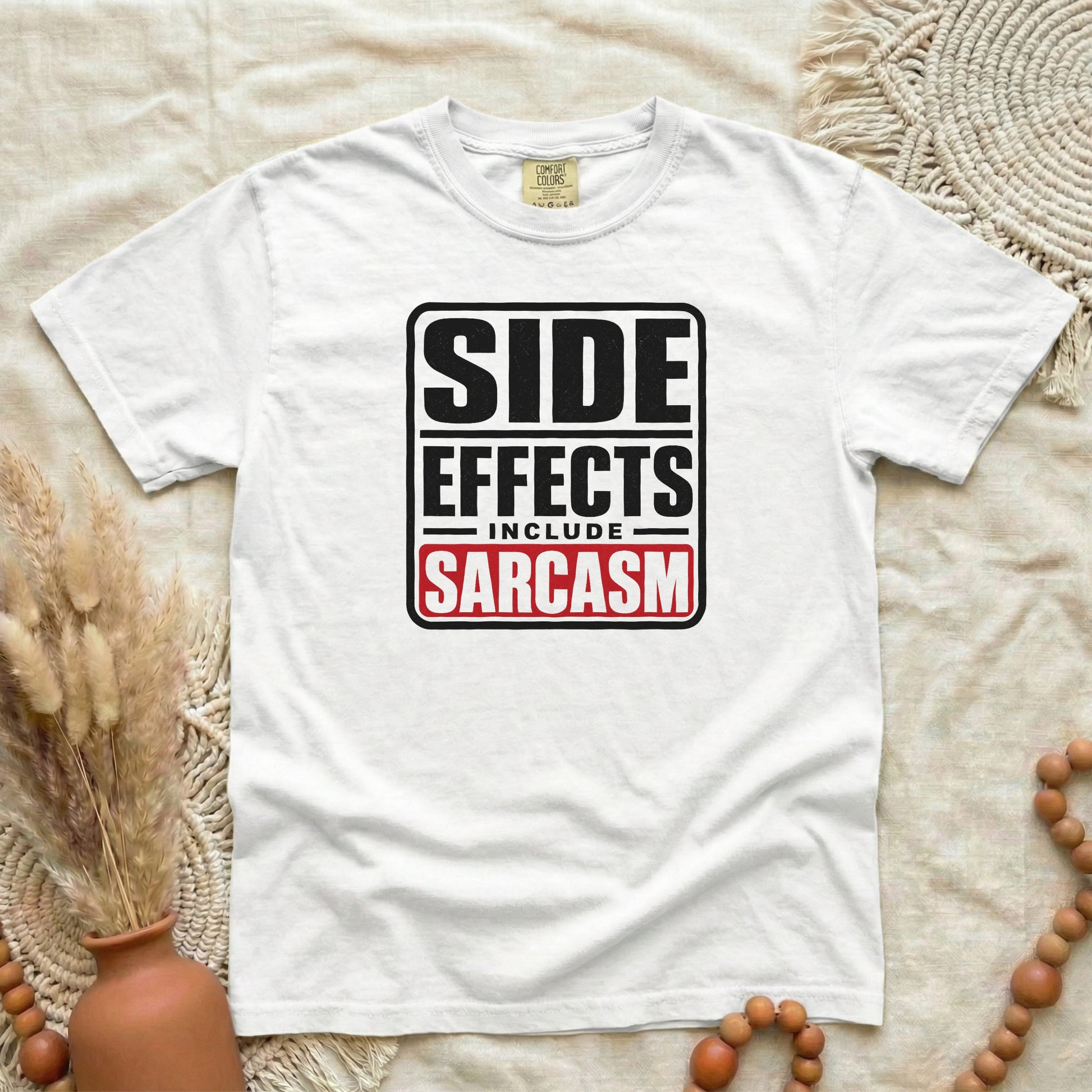 White garment-dyed cotton tee printed with "Side Effects Include Sarcasm".