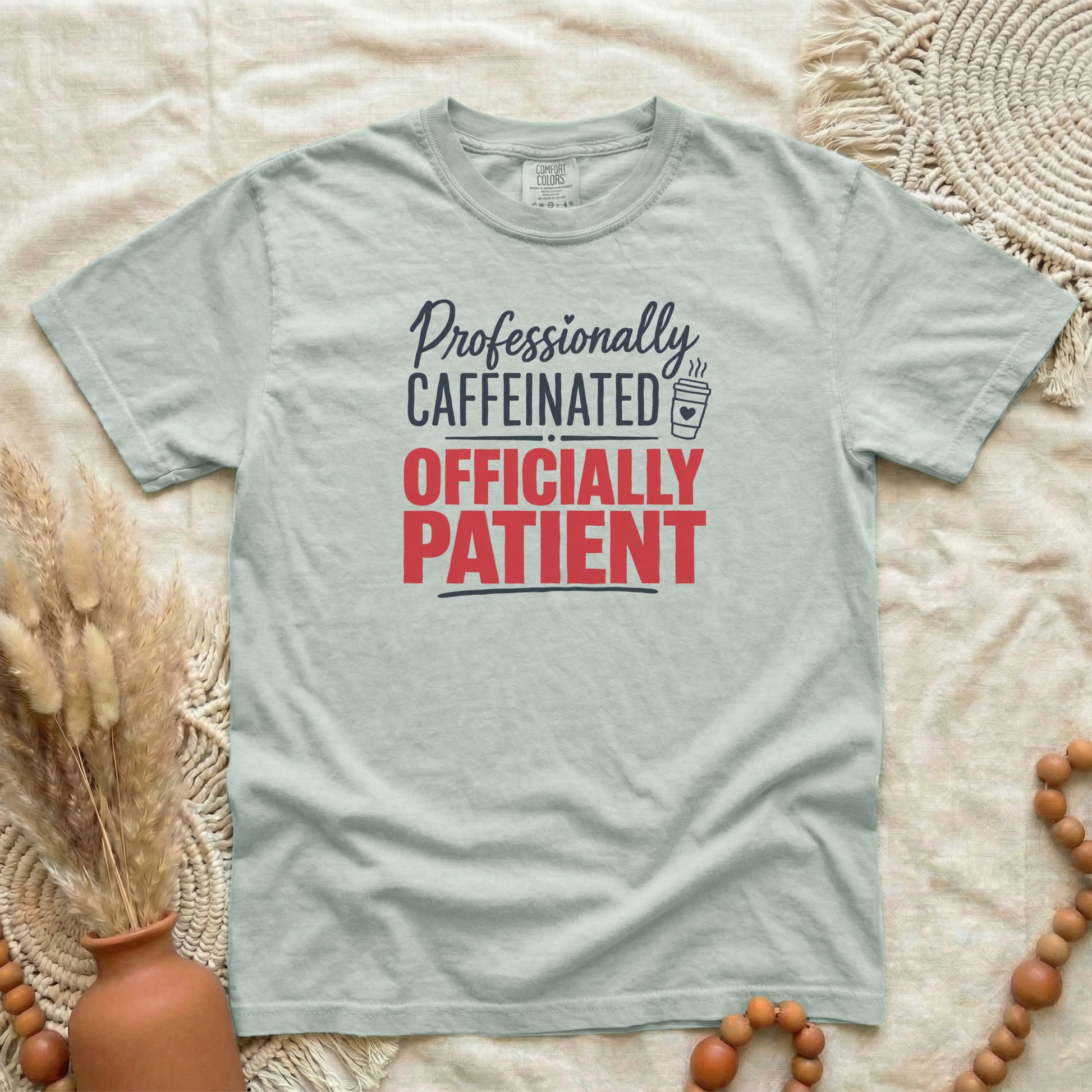 Bay garment-dyed cotton tee printed with "Professionally Caffeinated, Officially Patient".
