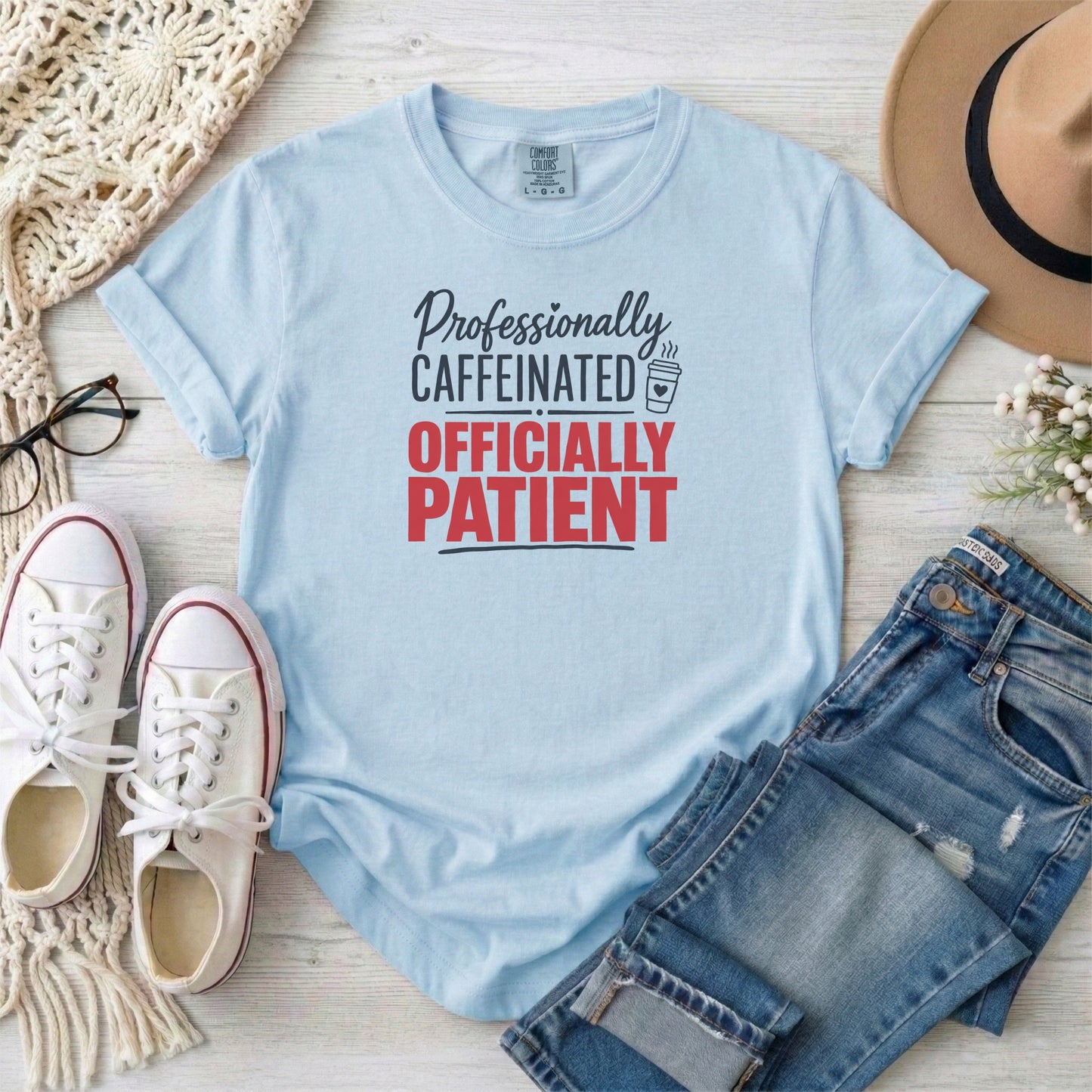 Chambray garment-dyed cotton tee printed with "Professionally Caffeinated, Officially Patient".