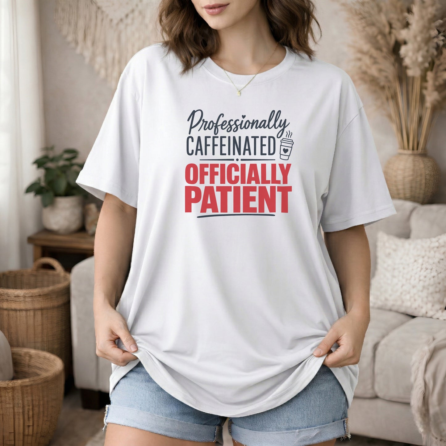 White garment-dyed cotton tee printed with "Professionally Caffeinated, Officially Patient".