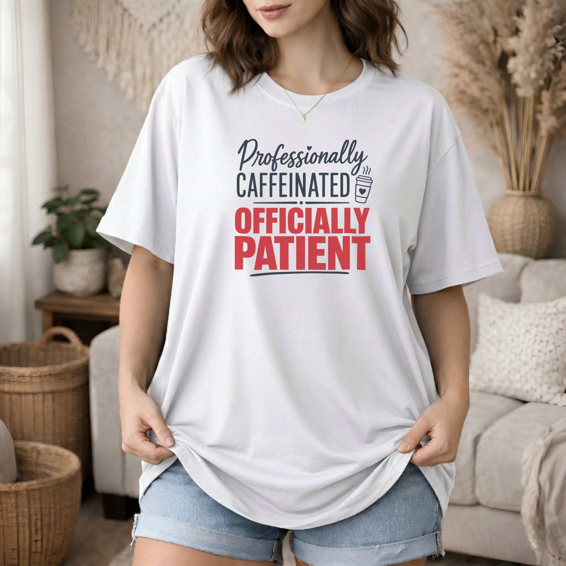 White garment-dyed cotton tee printed with "Professionally Caffeinated, Officially Patient".