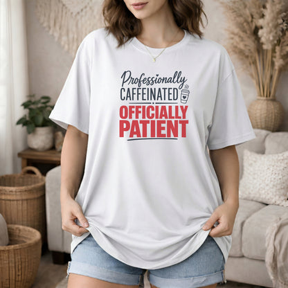 White garment-dyed cotton tee printed with "Professionally Caffeinated, Officially Patient".