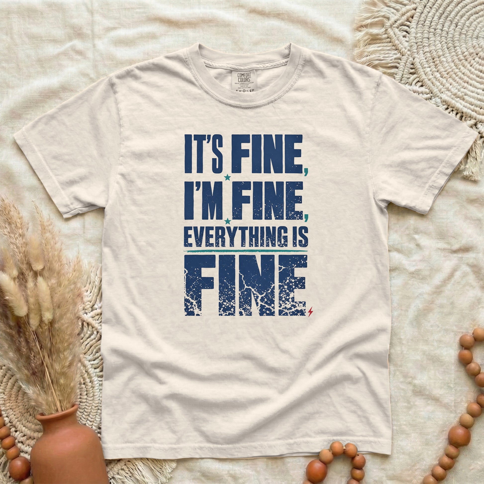 Ivory garment-dyed cotton tee printed with "It's Fine, I'm Fine, Everything Is Fine".