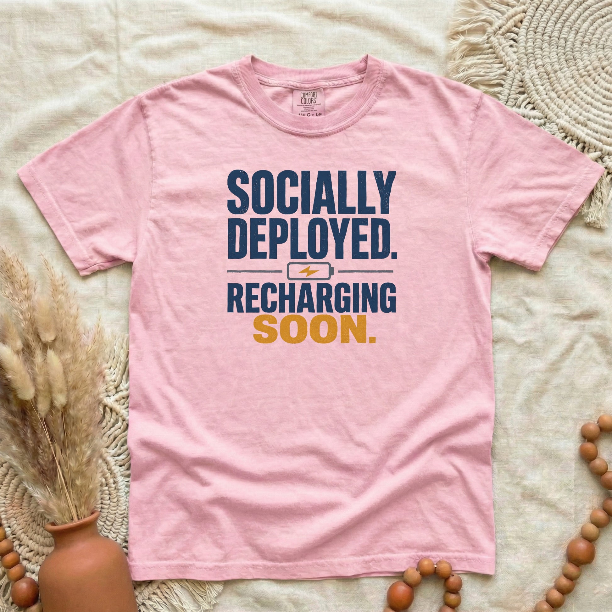 Blossom garment-dyed cotton tee printed with "Socially Deployed. Recharging Soon."