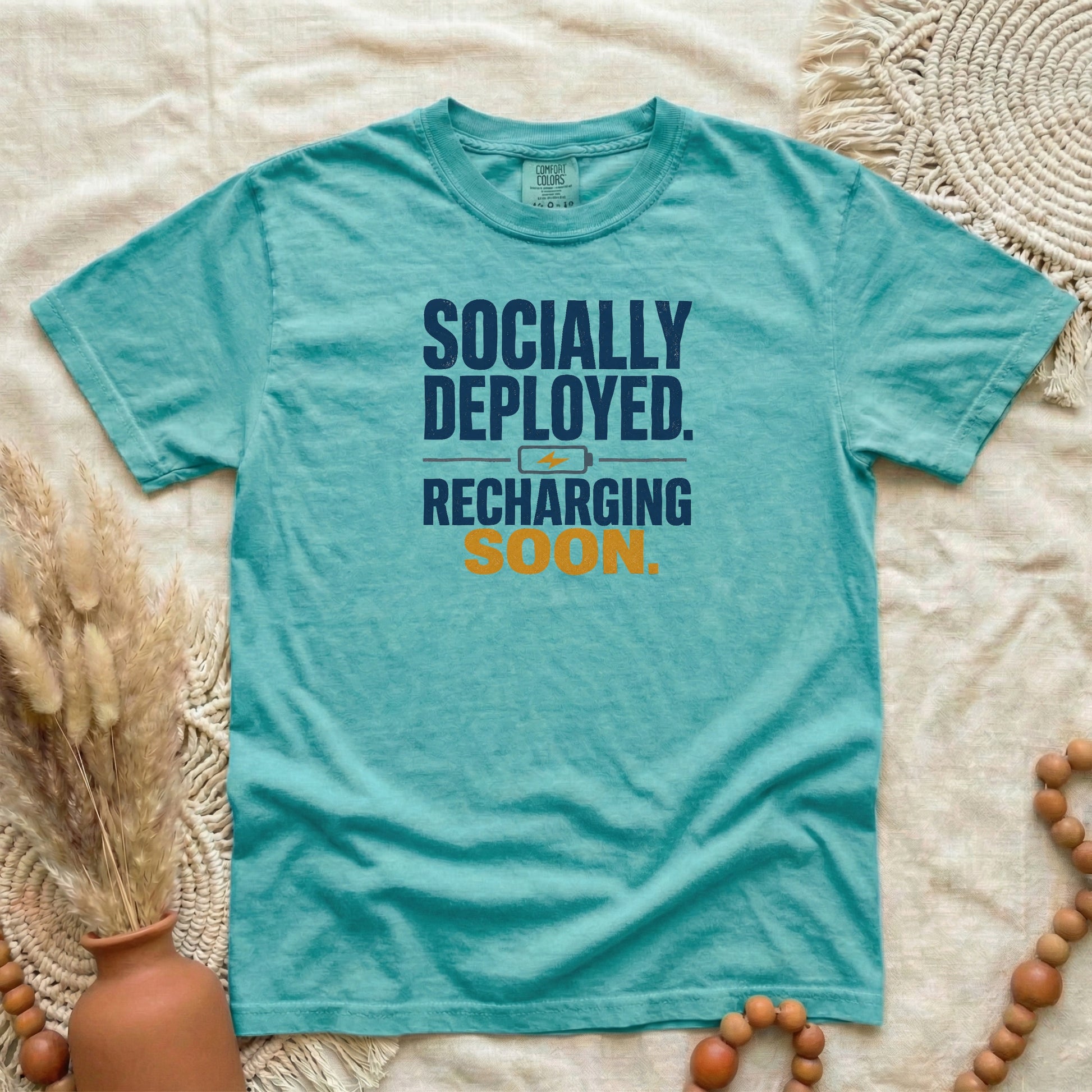 Seafoam garment-dyed cotton tee printed with "Socially Deployed. Recharging Soon."