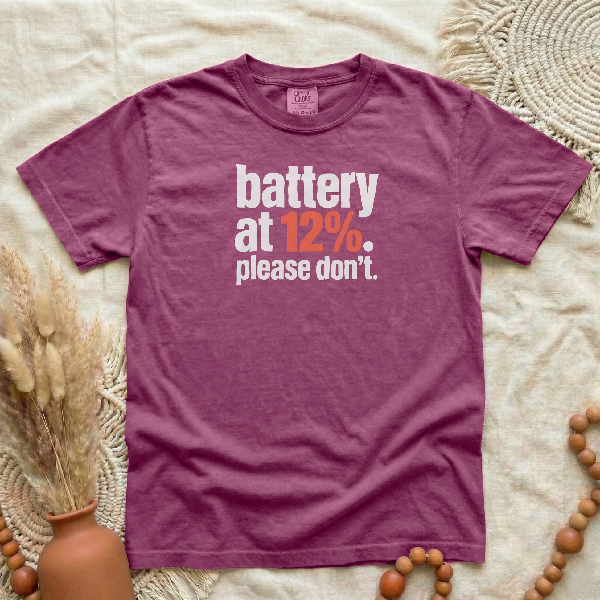 Berry garment-dyed cotton tee printed with "Battery At 12%. Please Don't."