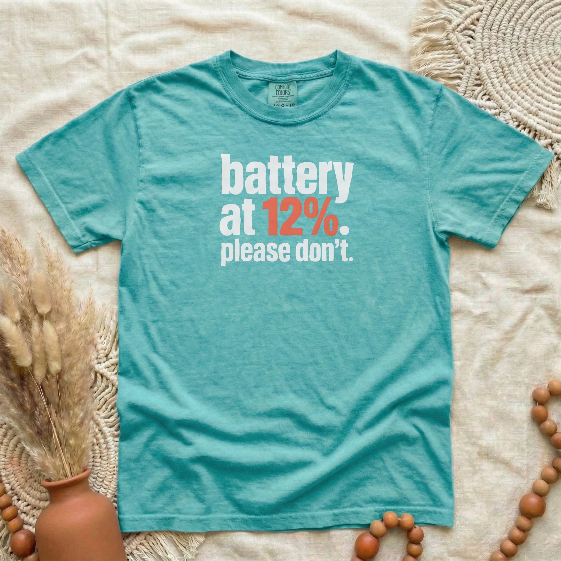 Seafoam garment-dyed cotton tee printed with "Battery At 12%. Please Don't."