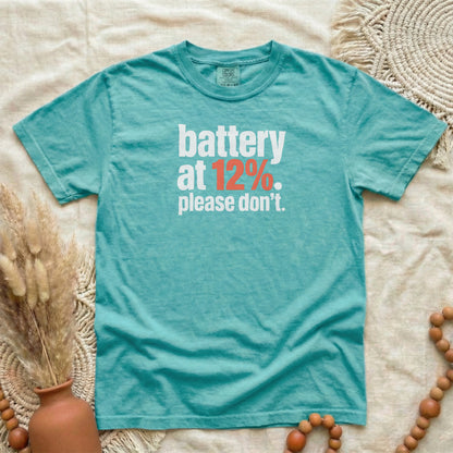 Seafoam garment-dyed cotton tee printed with "Battery At 12%. Please Don't."