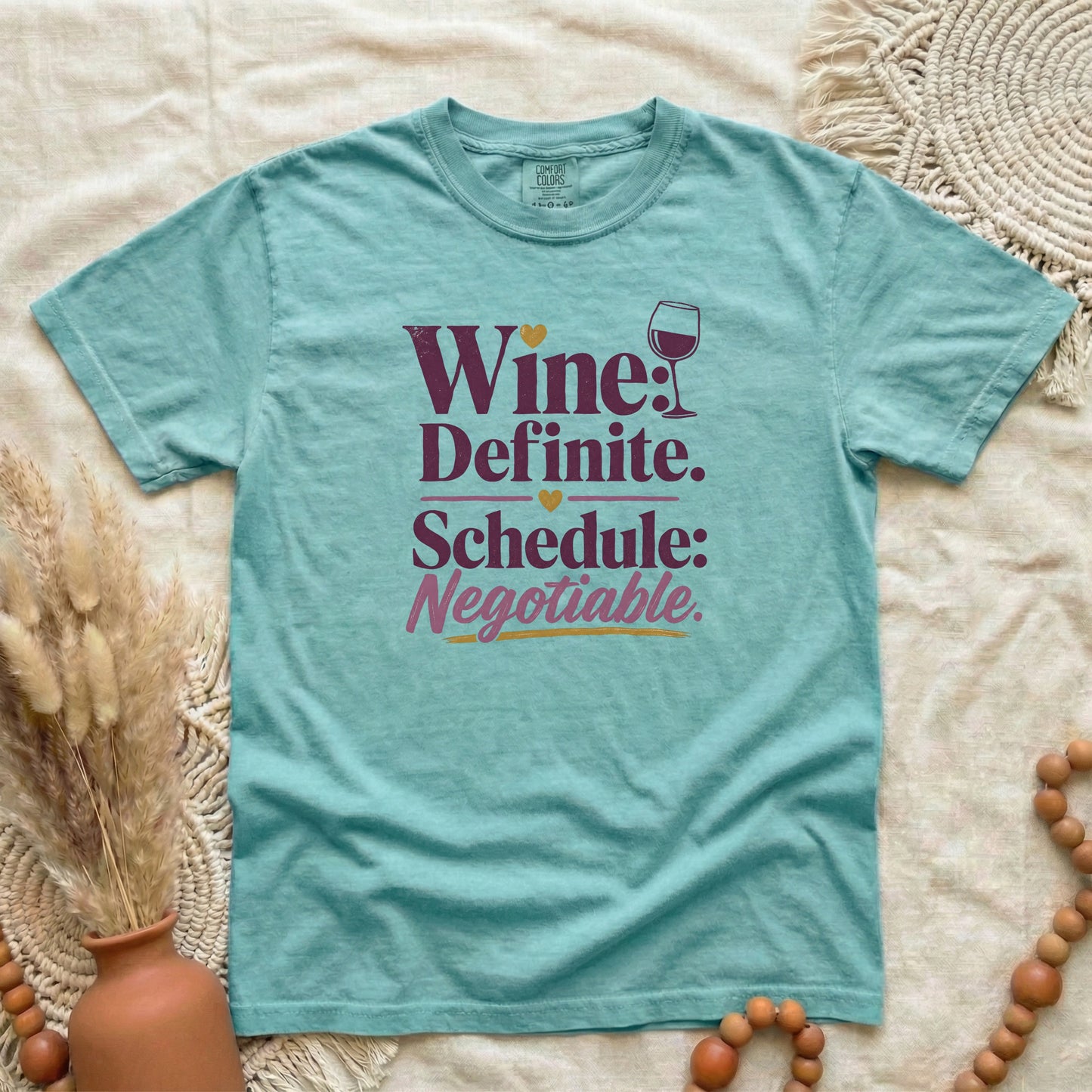 Chalky Mint garment-dyed cotton tee printed with "Wine: Definite. Schedule: Negotiable."