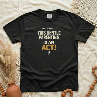 Black garment-dyed cotton tee printed with "This Gentle Parenting Is An Act".