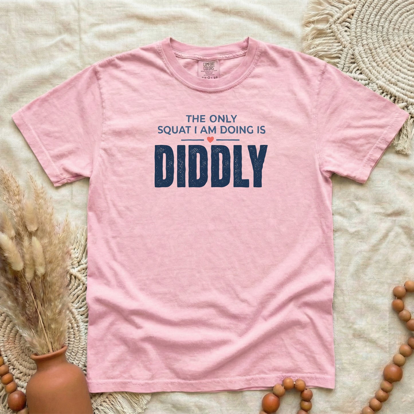 Blossom garment-dyed cotton tee printed with "The Only Squat I Am Doing Is Diddly".