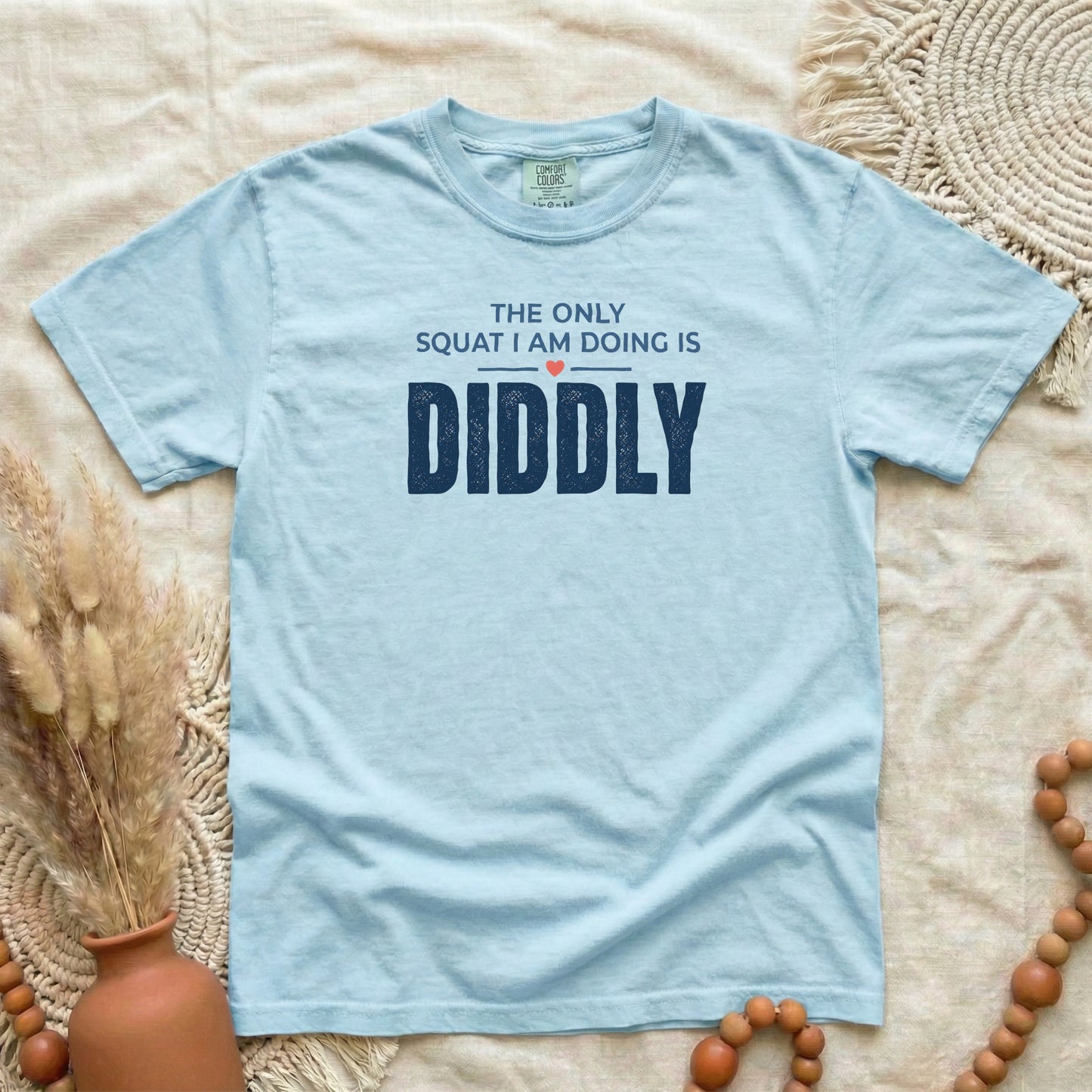 Chambray garment-dyed cotton tee printed with "The Only Squat I Am Doing Is Diddly".